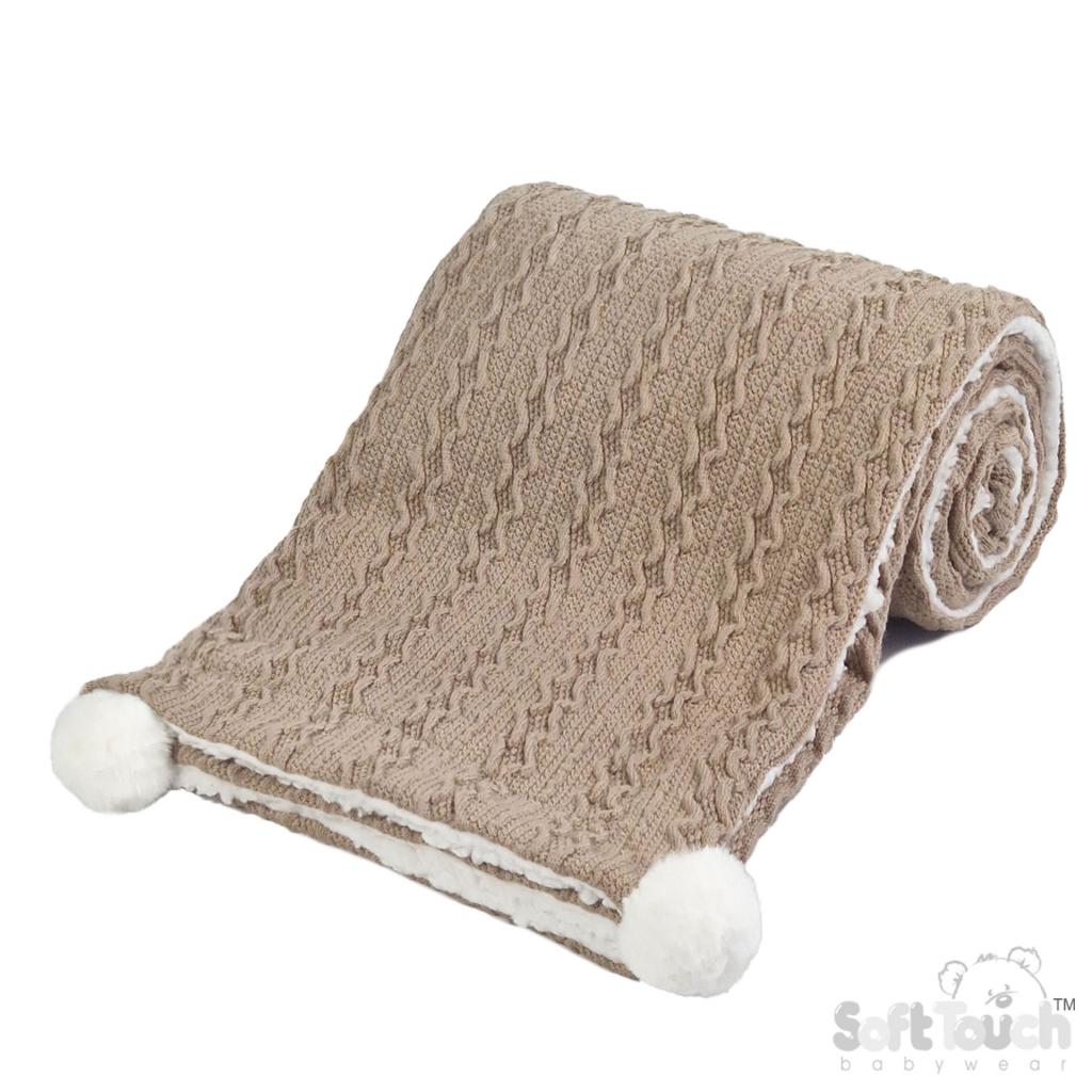 Personalised knitted baby blanket with white sherpa lining and 2 pom-poms.