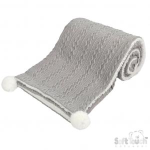 Personalised knitted baby blanket with white sherpa lining and 2 pom-poms.