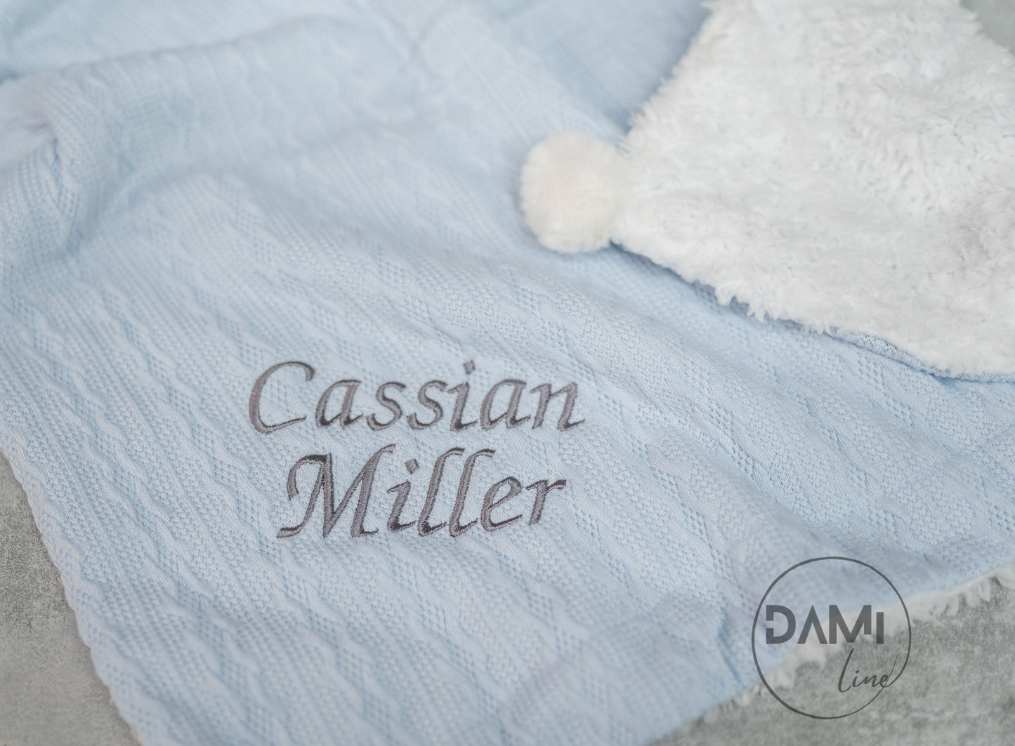 Personalised knitted LIGHT BLUE baby blanket with sherpa lining and 2 pom-poms.