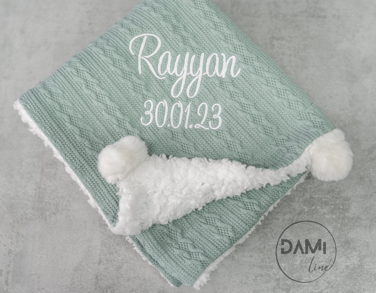 Personalised knitted SAGE baby blanket with sherpa lining and 2 pom-poms.