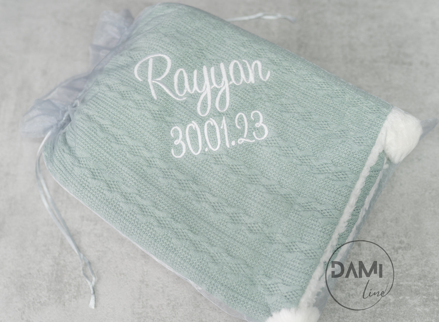 Personalised knitted SAGE baby blanket with sherpa lining and 2 pom-poms.