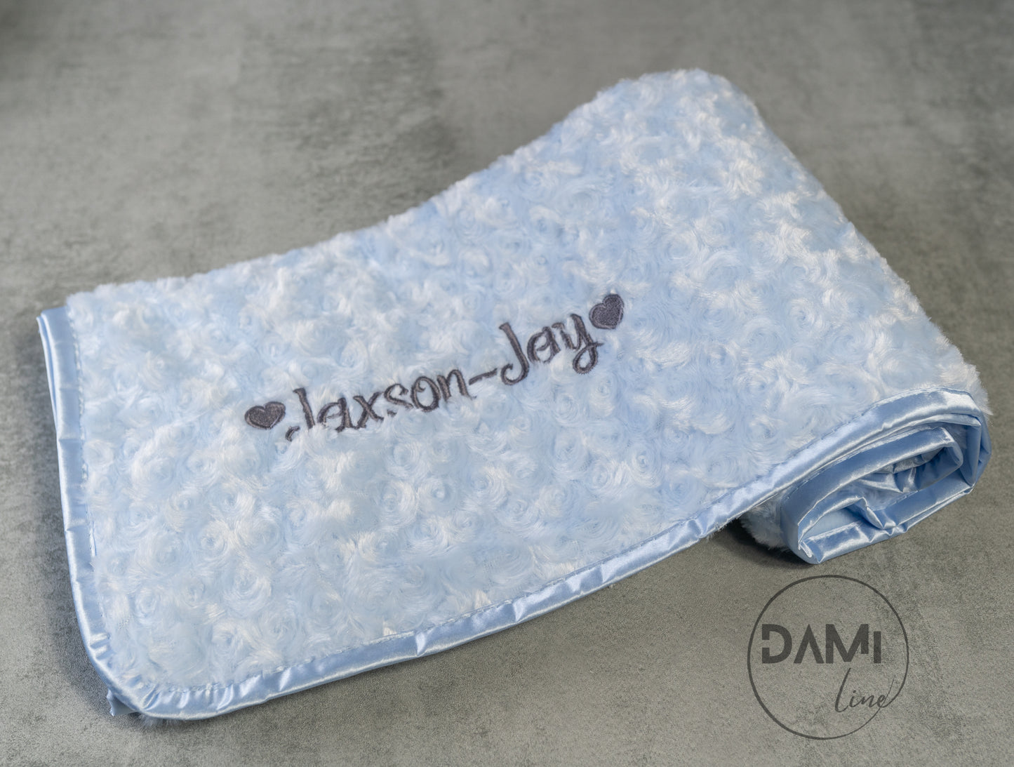 Personalised embroidered baby rosebud blanket with fleece back and satin trim.