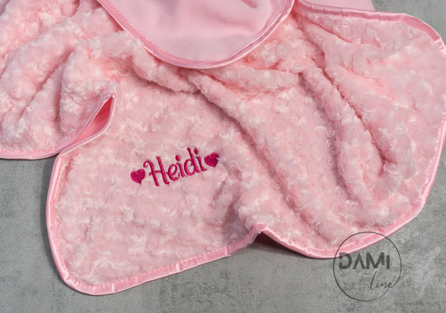 Personalised embroidered baby rosebud blanket with fleece back and satin trim.