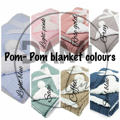 Personalised knitted baby blanket with white sherpa lining and 2 pom-poms.